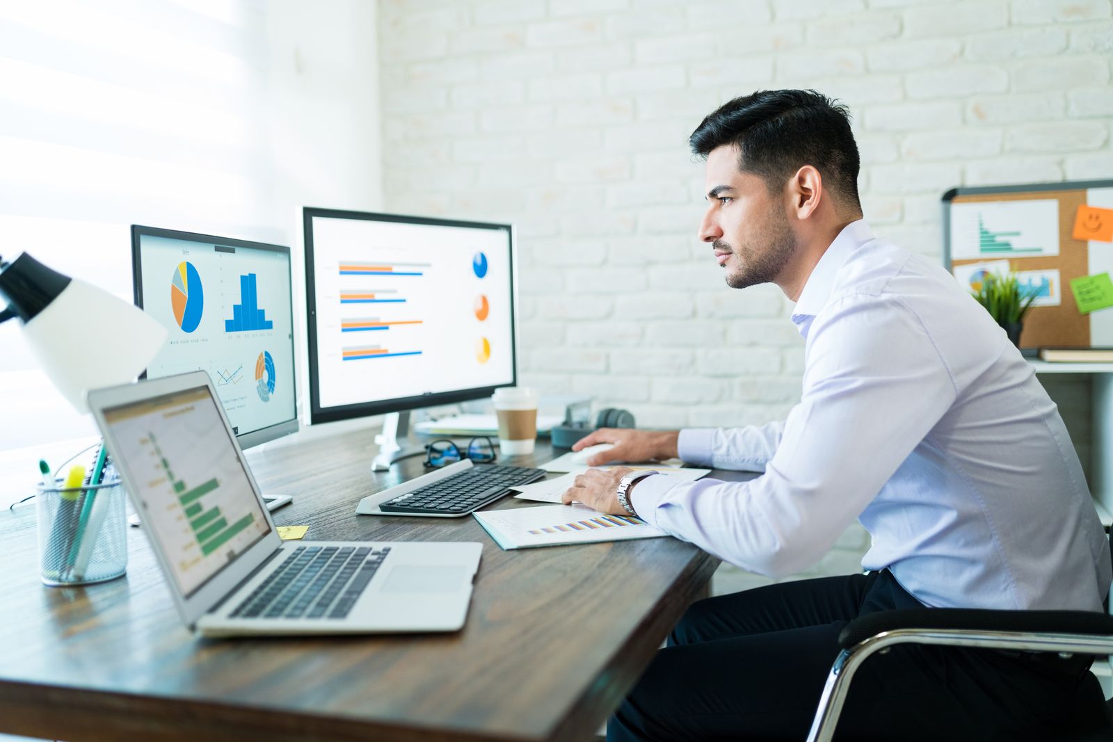 Marketing specialist reviewing analytics dashboards on screen