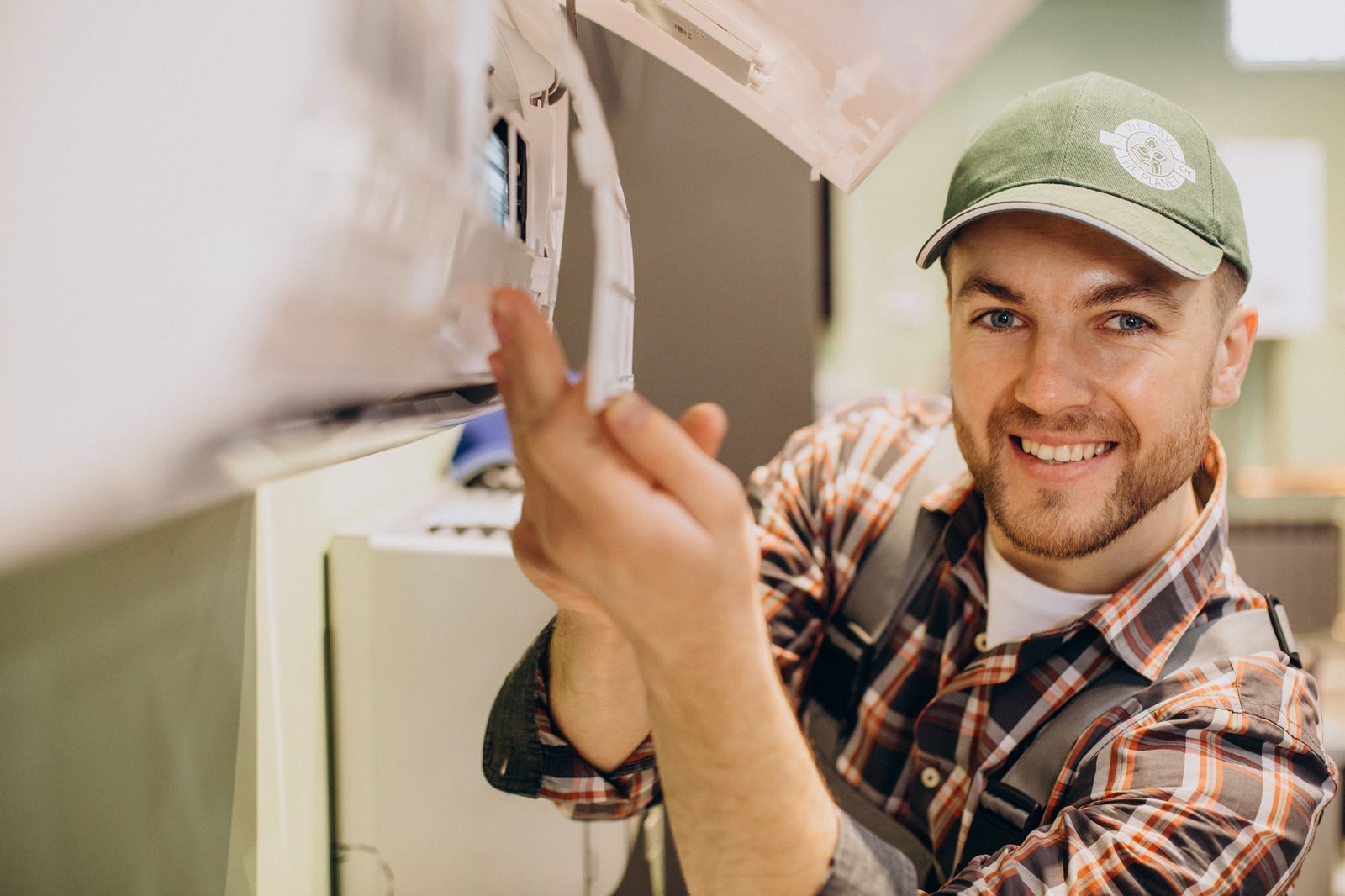 Smiling HVAC technician servicing an air conditioning unit