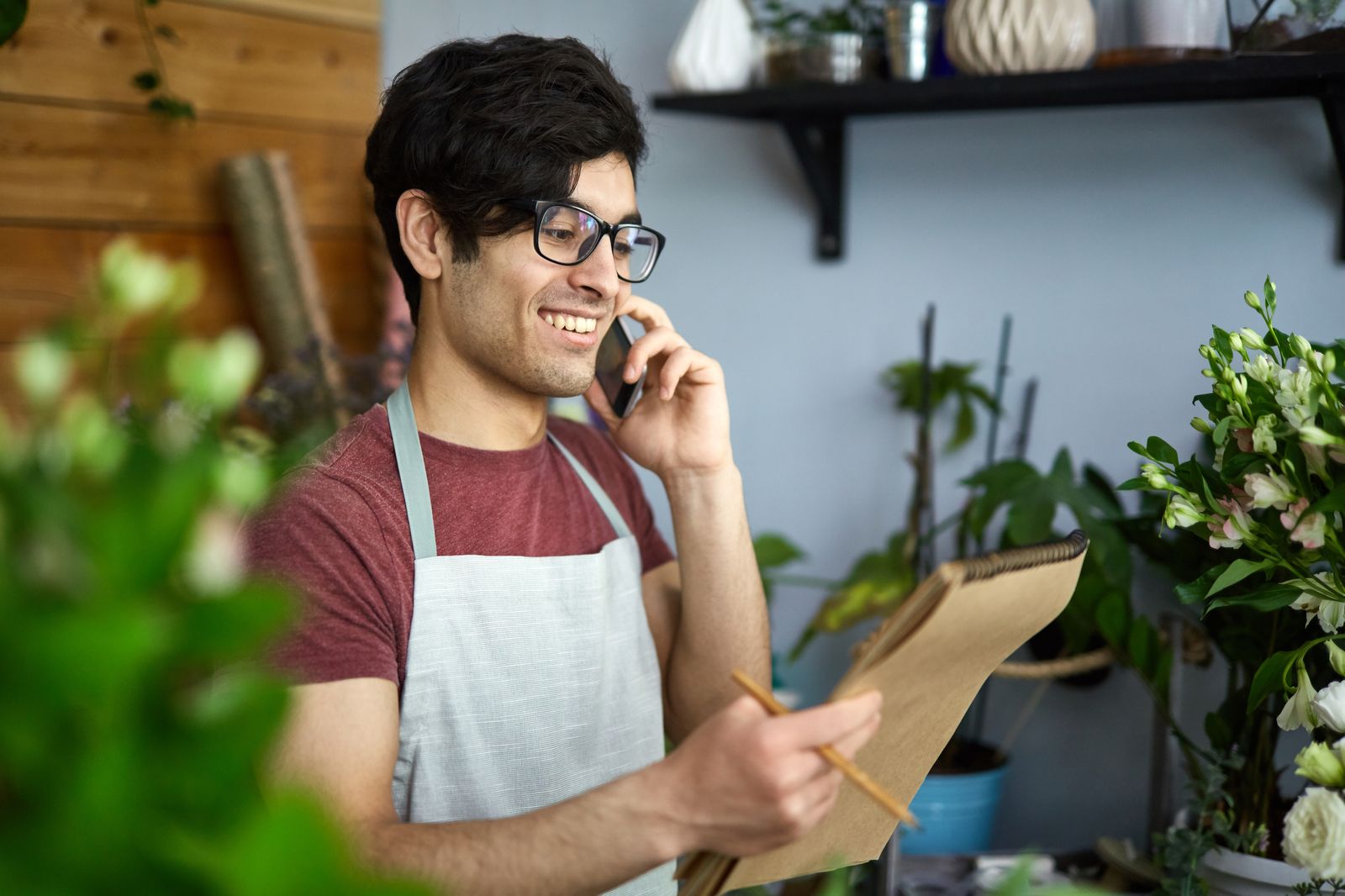 Small business owner taking a customer order on the phone